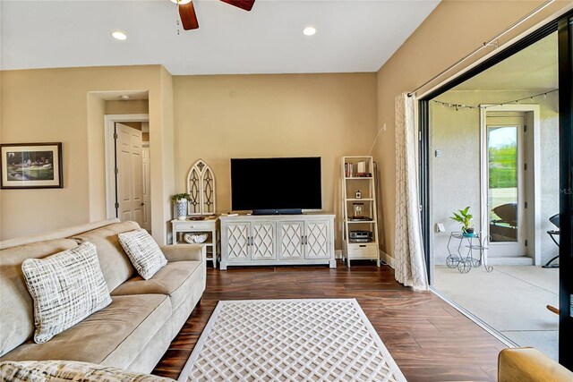 living room with dark hardwood / wood-style floors and ceiling fan