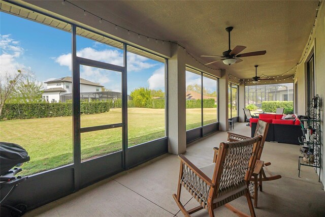 sunroom featuring plenty of natural light and ceiling fan