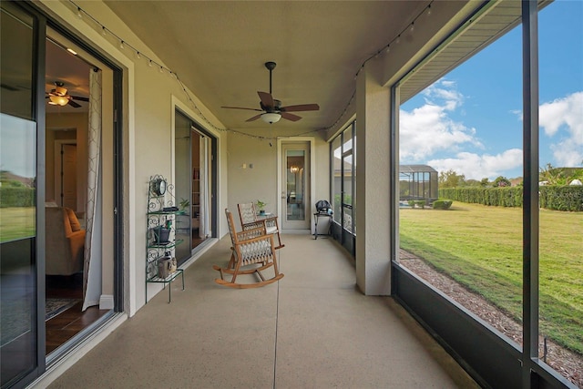 sunroom / solarium featuring ceiling fan