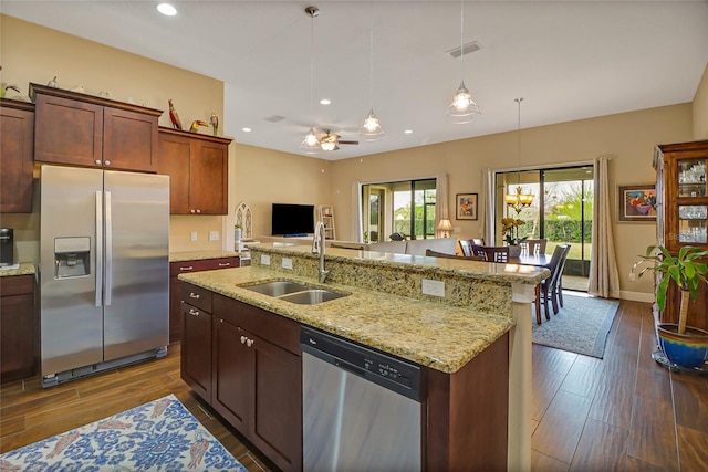 kitchen with ceiling fan, stainless steel appliances, decorative light fixtures, dark hardwood / wood-style flooring, and sink