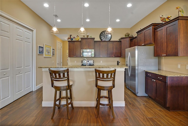 kitchen with decorative light fixtures, dark hardwood / wood-style flooring, and stainless steel appliances