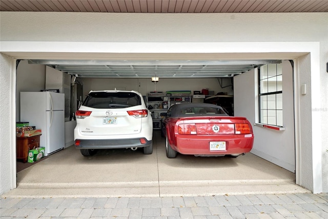 garage featuring white fridge