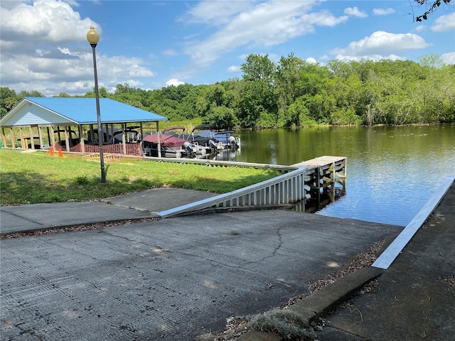 view of dock with a water view and a yard