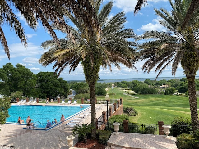 view of swimming pool featuring a lawn