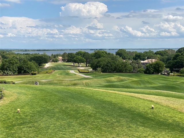 surrounding community featuring a water view and a yard