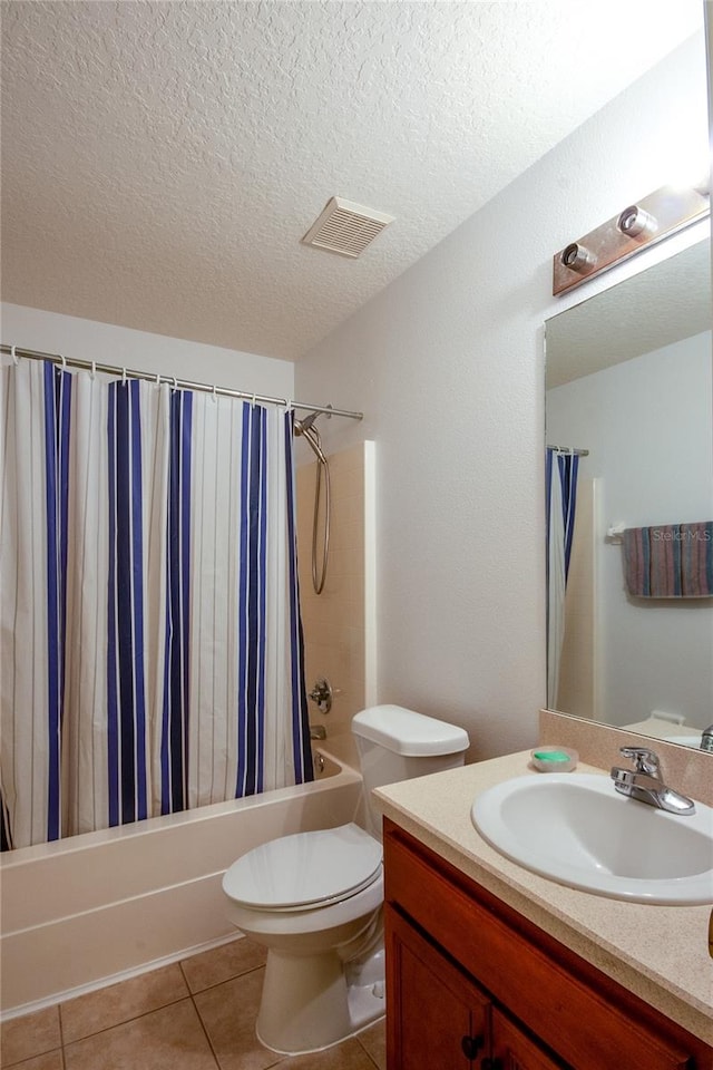 full bathroom featuring a textured ceiling, vanity, shower / tub combo, toilet, and tile patterned floors