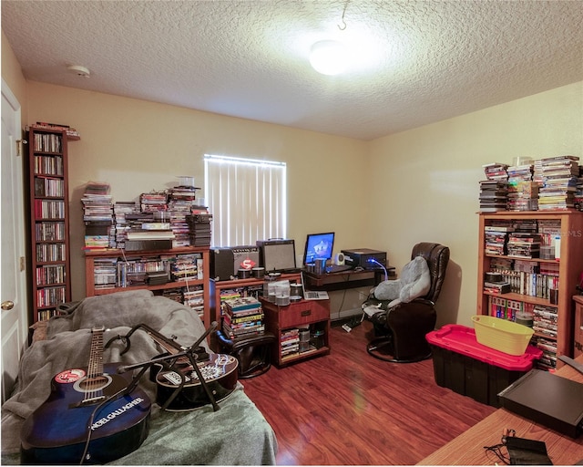 home office featuring hardwood / wood-style flooring and a textured ceiling