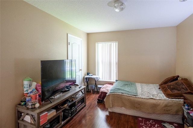 bedroom with dark hardwood / wood-style floors