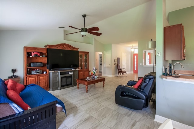 living room featuring ceiling fan, sink, and vaulted ceiling