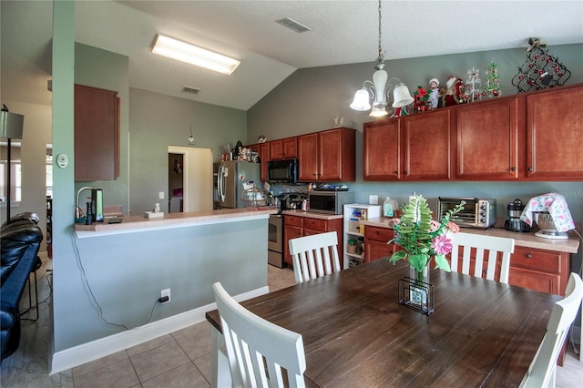 dining area with lofted ceiling, an inviting chandelier, and light tile patterned floors