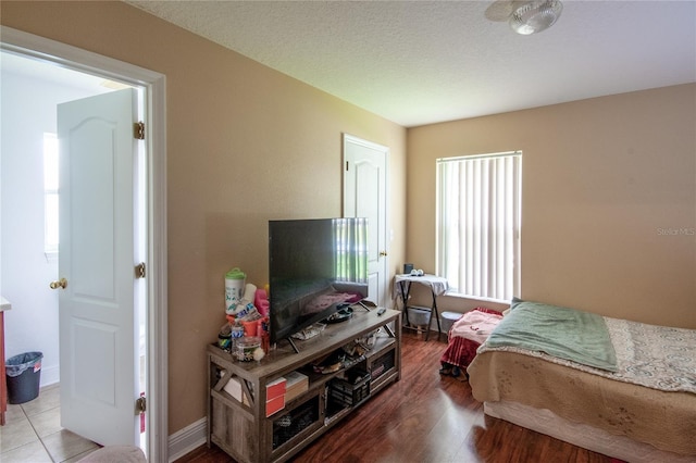 bedroom with a textured ceiling and hardwood / wood-style floors