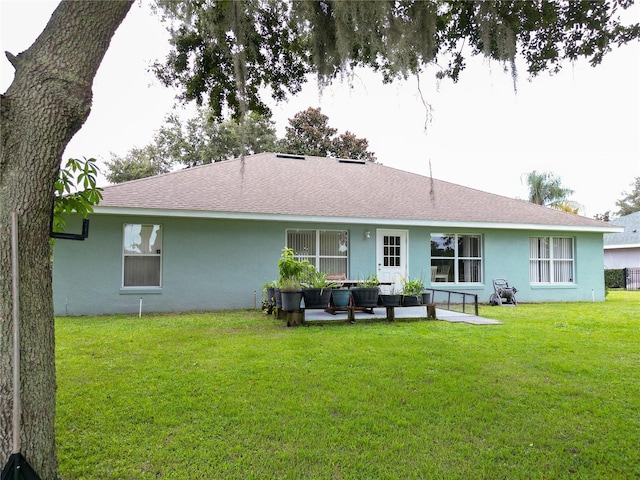 back of property with outdoor lounge area, a yard, and a patio