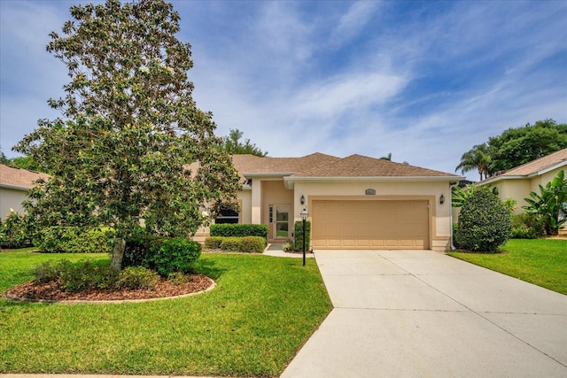 view of front of property with a front lawn and a garage