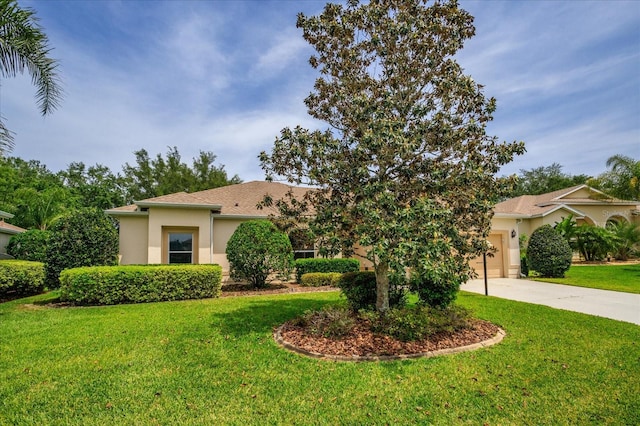 mediterranean / spanish-style home with a front lawn and a garage