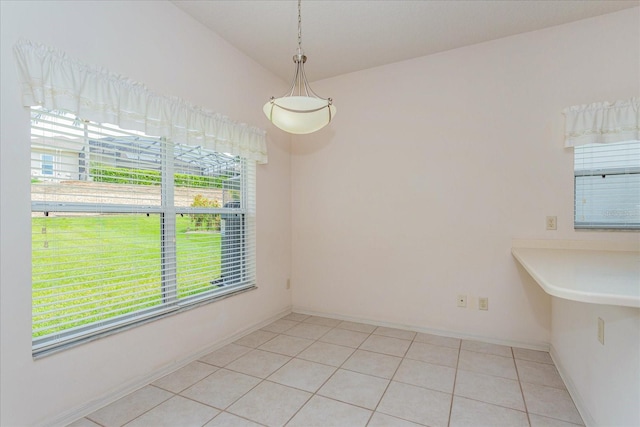 unfurnished dining area with a healthy amount of sunlight and light tile patterned floors