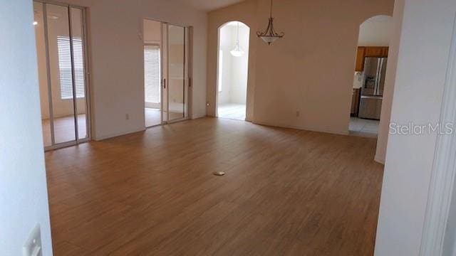 unfurnished living room featuring hardwood / wood-style flooring