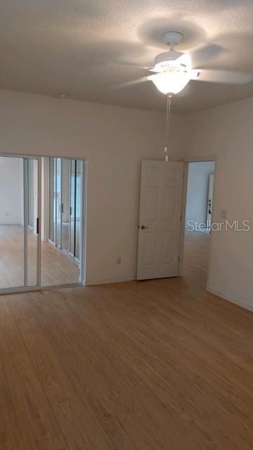 unfurnished room featuring ceiling fan and hardwood / wood-style floors