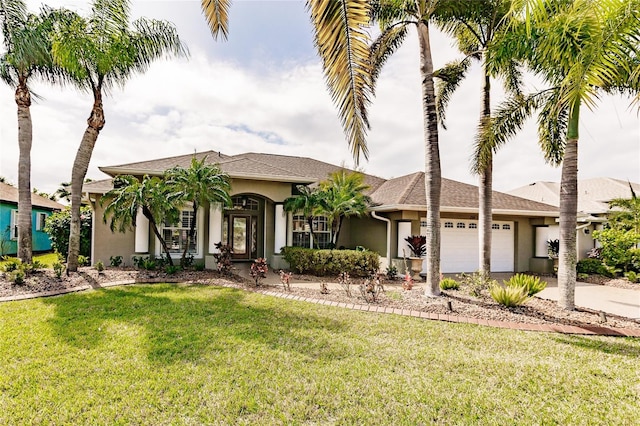 view of front of property featuring a front yard and a garage