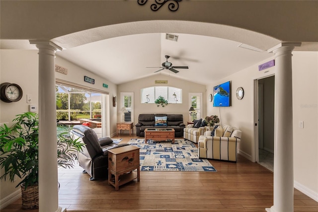 living room featuring ceiling fan, dark wood-type flooring, ornate columns, and vaulted ceiling