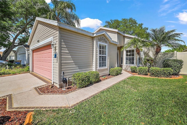 view of front of home with a front yard and a garage