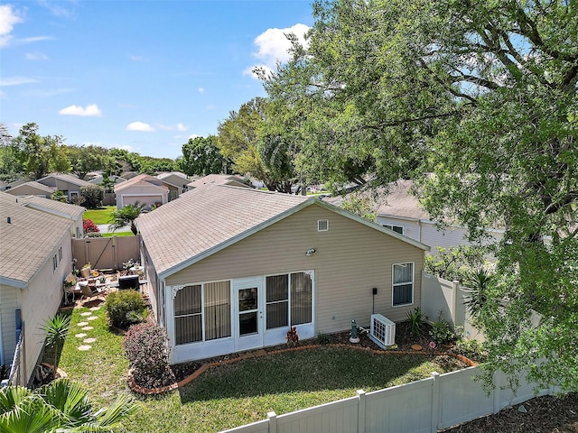 back of property with a lawn