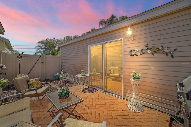 view of patio terrace at dusk