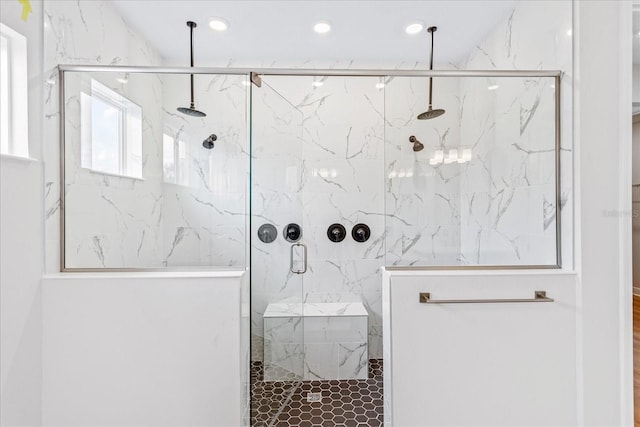 bathroom with a marble finish shower and recessed lighting