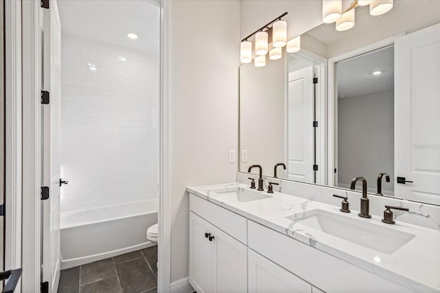 bathroom with  shower combination, a sink, toilet, and double vanity