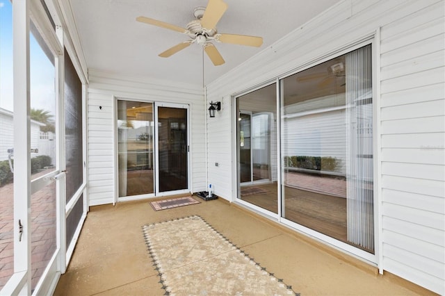 unfurnished sunroom with ceiling fan