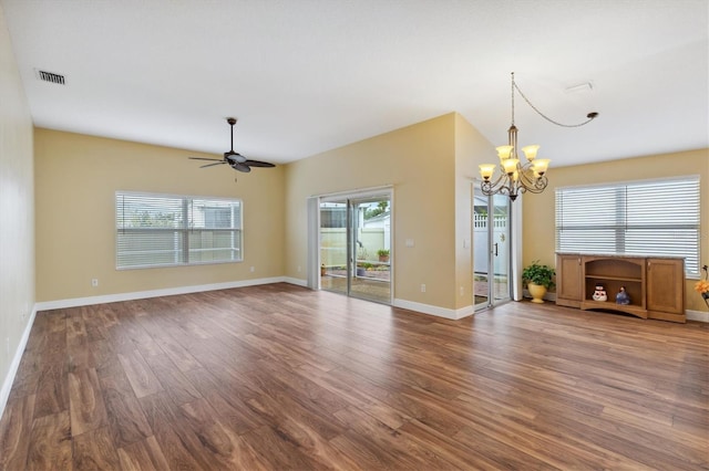 unfurnished living room with ceiling fan with notable chandelier and hardwood / wood-style flooring