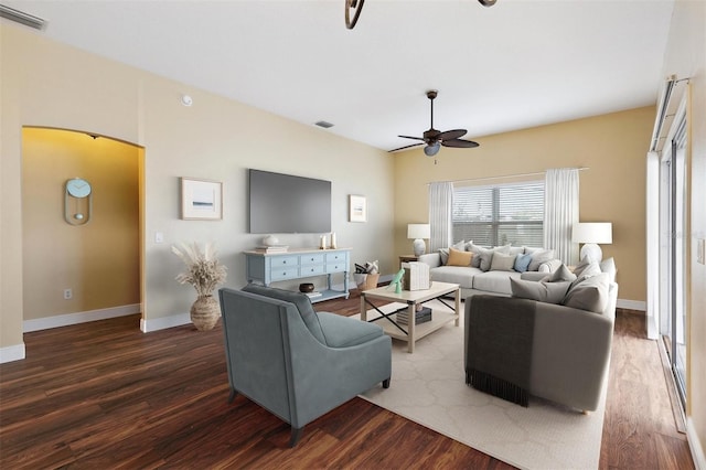 living room with ceiling fan and dark wood-type flooring