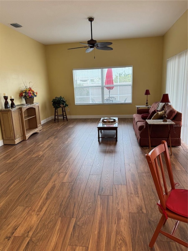 living room with ceiling fan and dark hardwood / wood-style floors