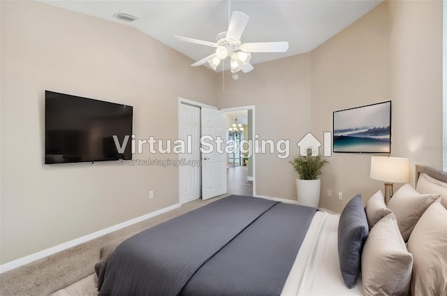 bedroom featuring ceiling fan with notable chandelier, vaulted ceiling, and carpet floors