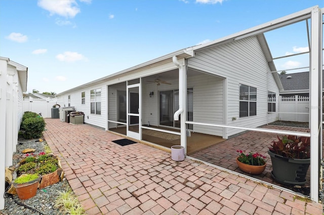 back of house with a patio, ceiling fan, a sunroom, and central AC unit