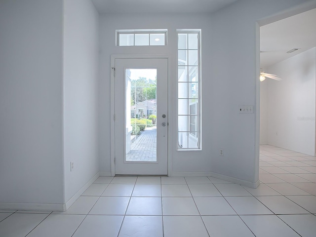 entryway featuring light tile floors and ceiling fan