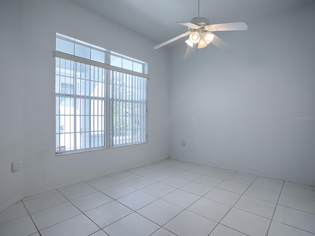 spare room featuring ceiling fan and light tile floors