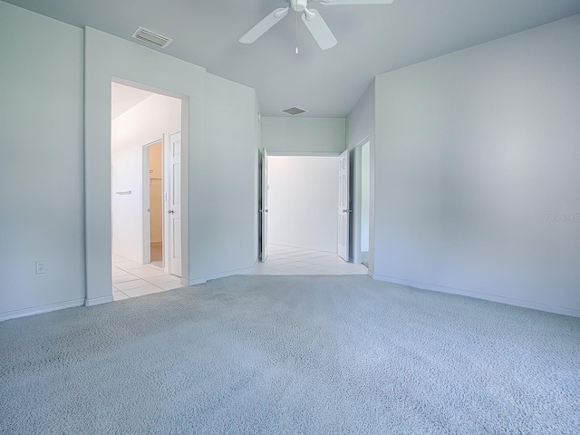 carpeted spare room featuring ceiling fan