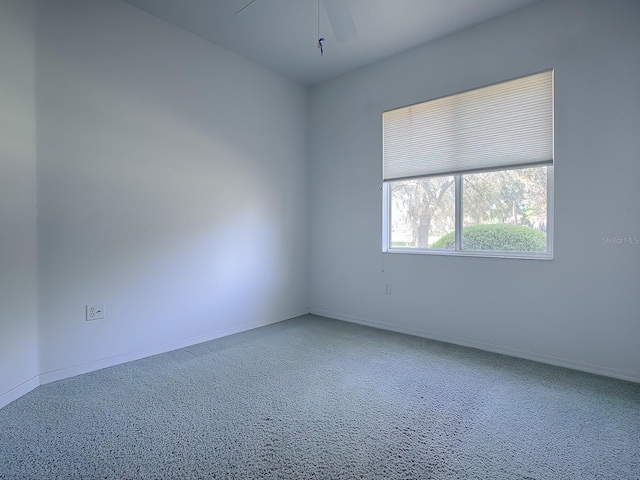 unfurnished room featuring light colored carpet and ceiling fan