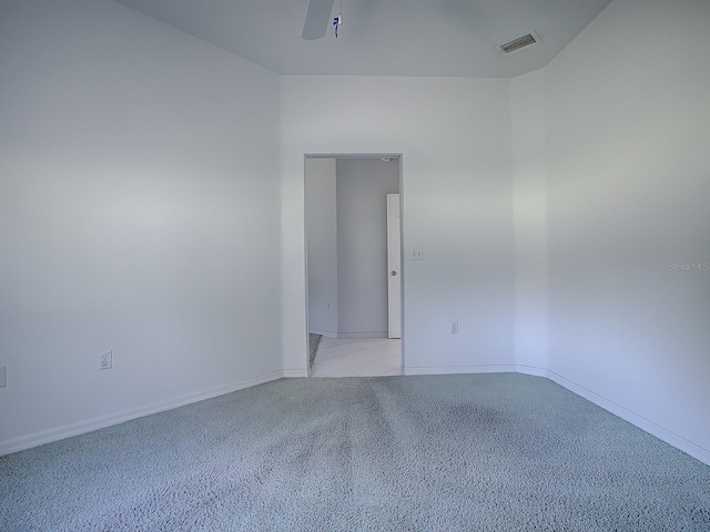 spare room with light colored carpet and ceiling fan