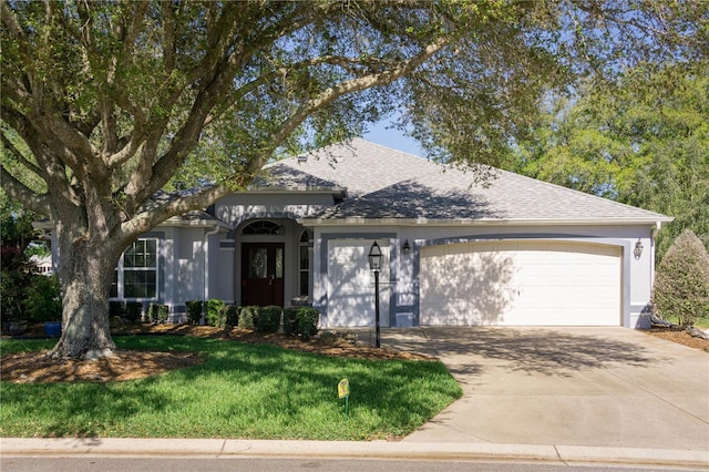 view of front facade featuring a front yard and a garage