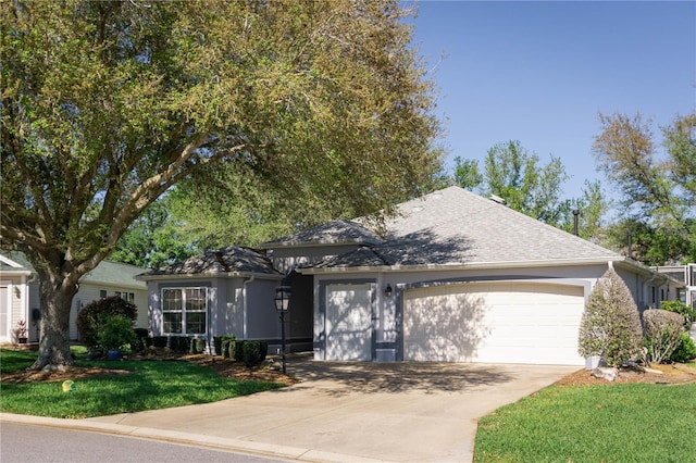 view of front of home featuring a garage and a front lawn