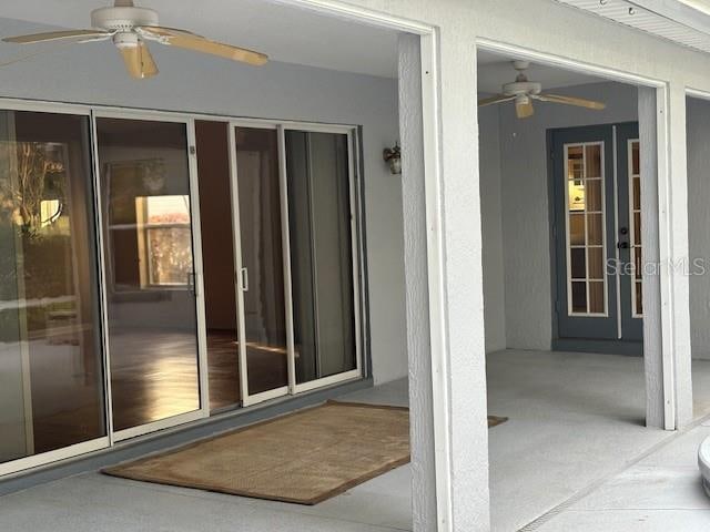 view of exterior entry featuring a patio area and ceiling fan