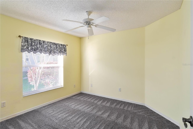 empty room with carpet flooring, ceiling fan, and a textured ceiling