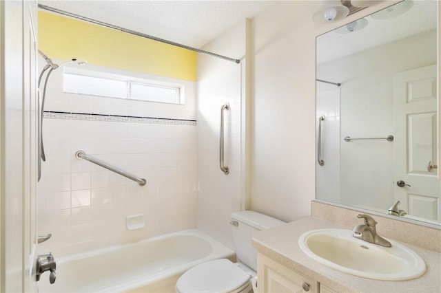 full bathroom with vanity, toilet, a textured ceiling, and tiled shower / bath combo