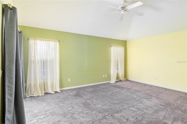 carpeted spare room featuring ceiling fan and a textured ceiling