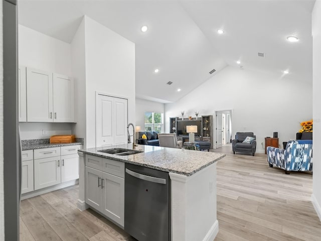 kitchen with white cabinetry, light hardwood / wood-style flooring, dishwasher, and light stone counters