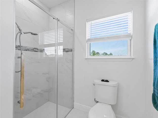 bathroom featuring an enclosed shower and toilet