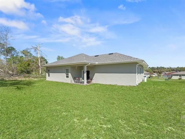 back of house featuring a yard and a patio area