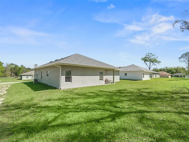 rear view of property featuring a lawn