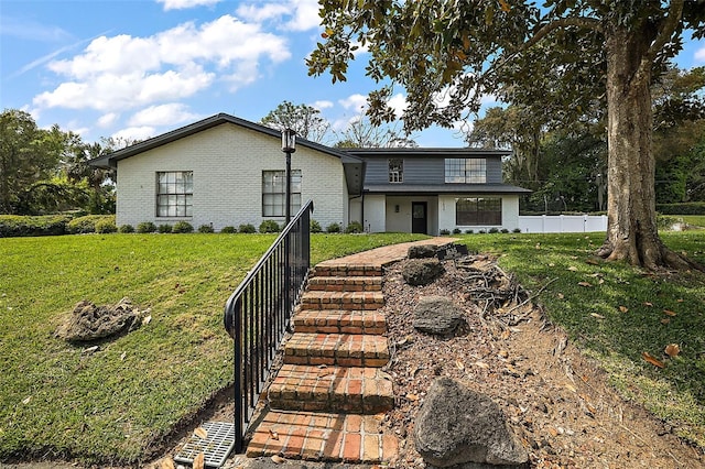 back of house with a lawn